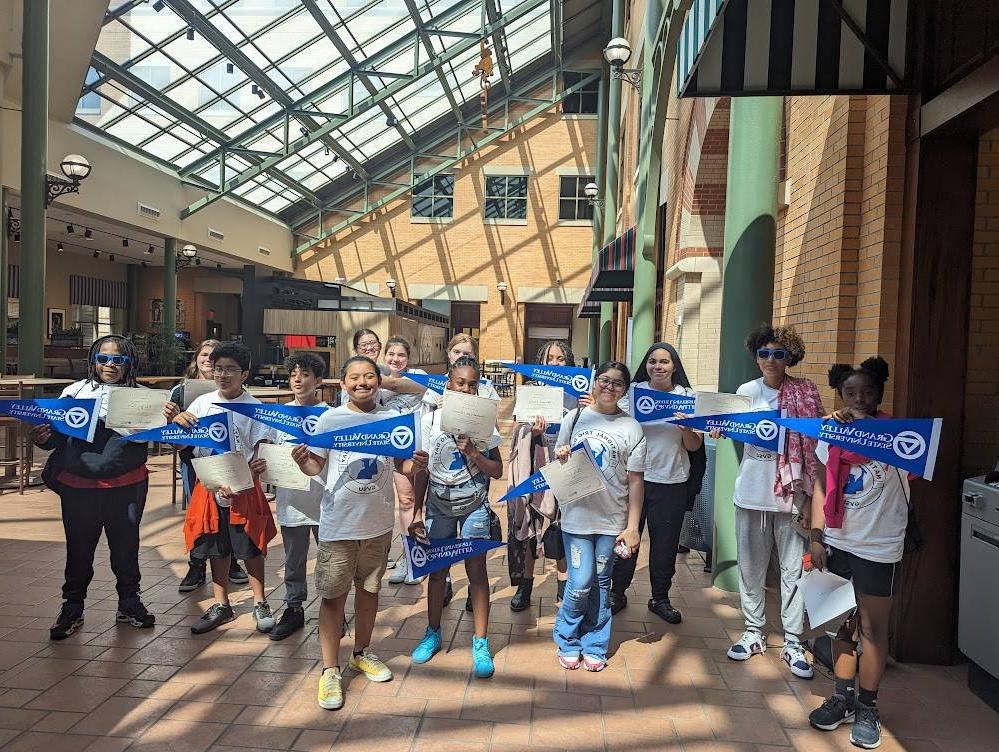 TRIO students with GVSU pennants